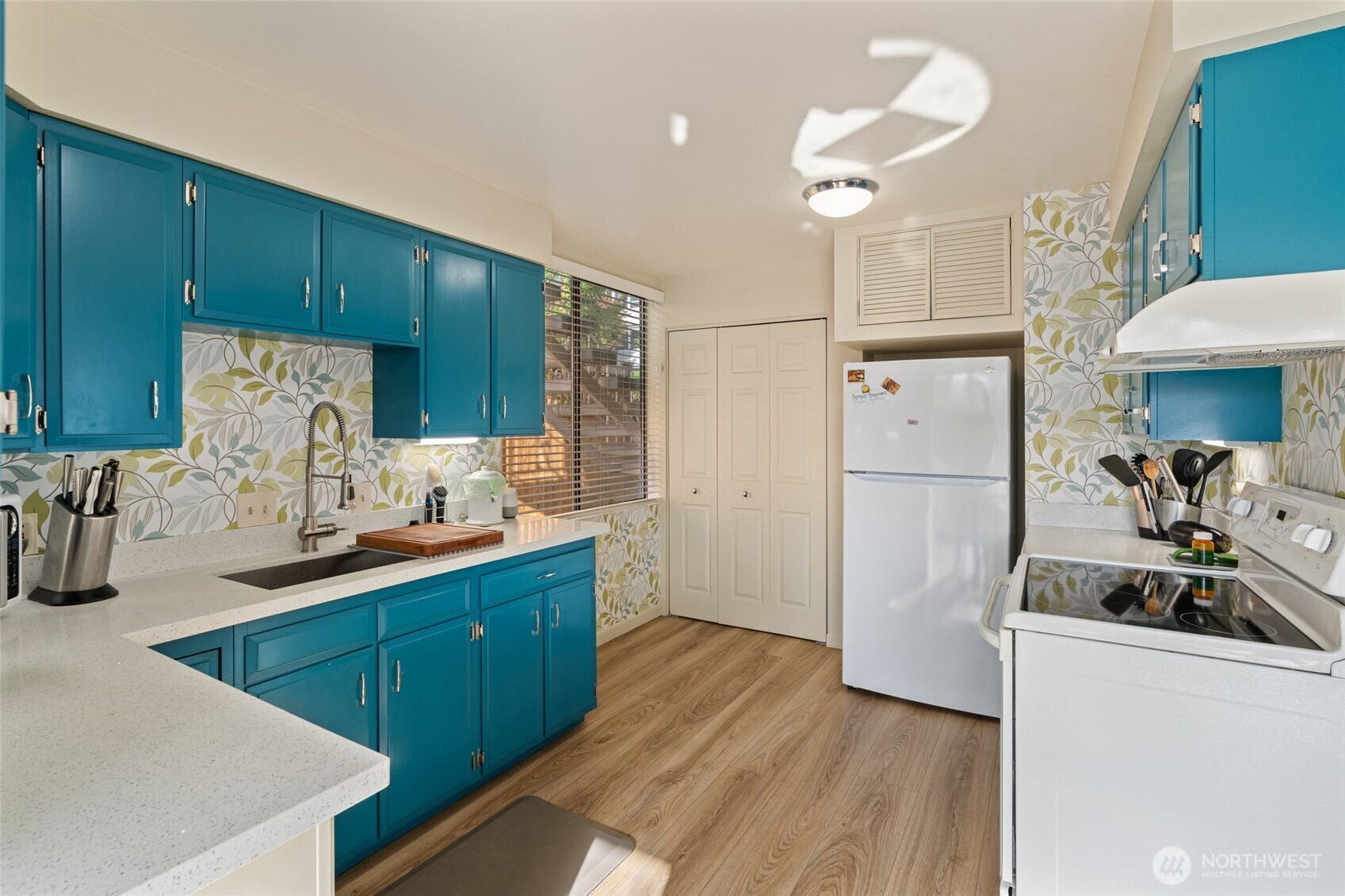 561 Lee Street Seattle, WA 98109 - Photo 9 of 40 a kitchen with wooden cabinets and a sink