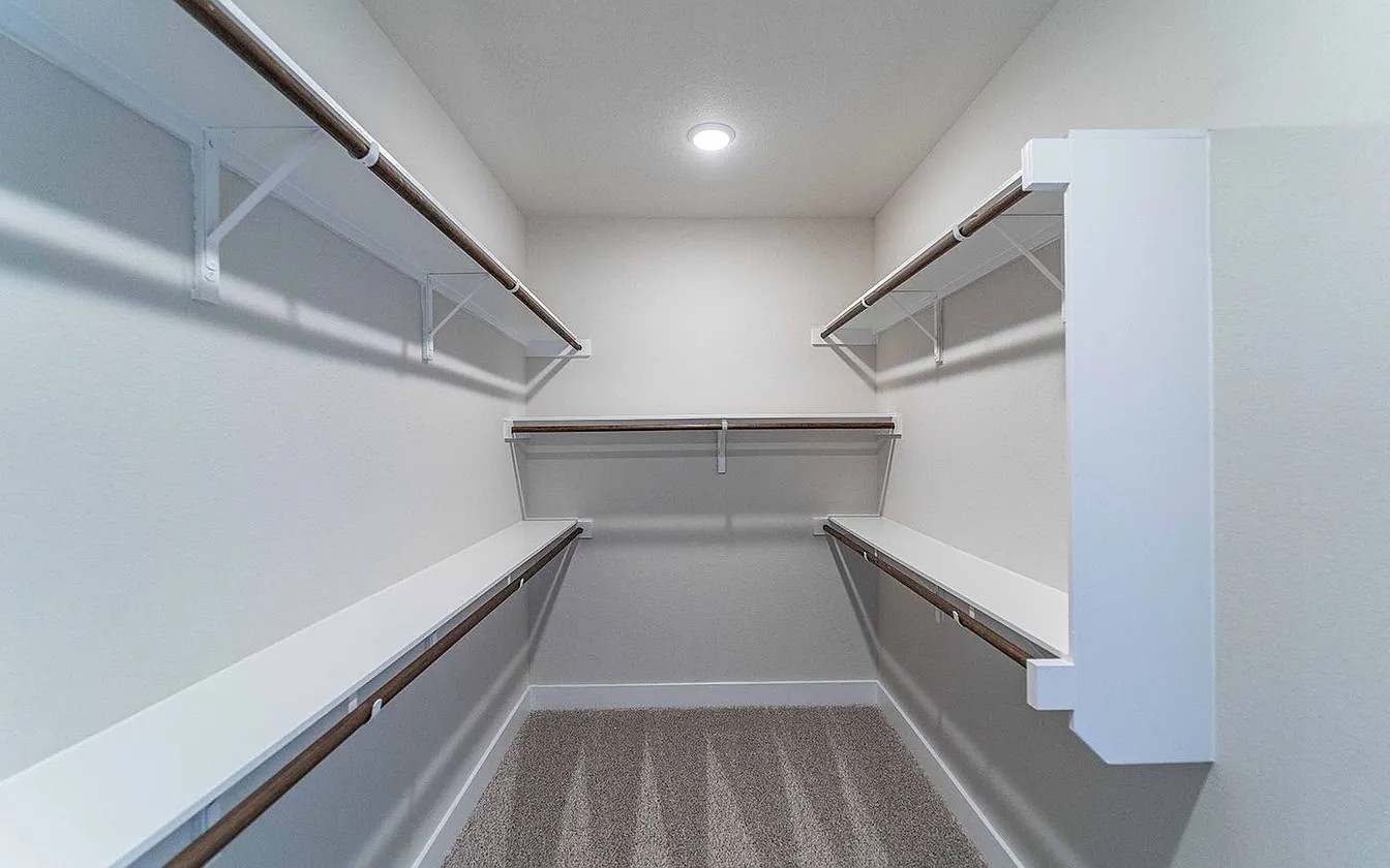 450 Durian Loop Buda, TX 78610 - Photo 5 of 17 Ample shelving and hanging space defines this well-organized walk-in closet.