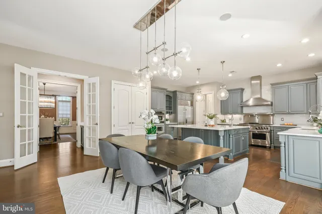 a living room with furniture and floor to ceiling windows