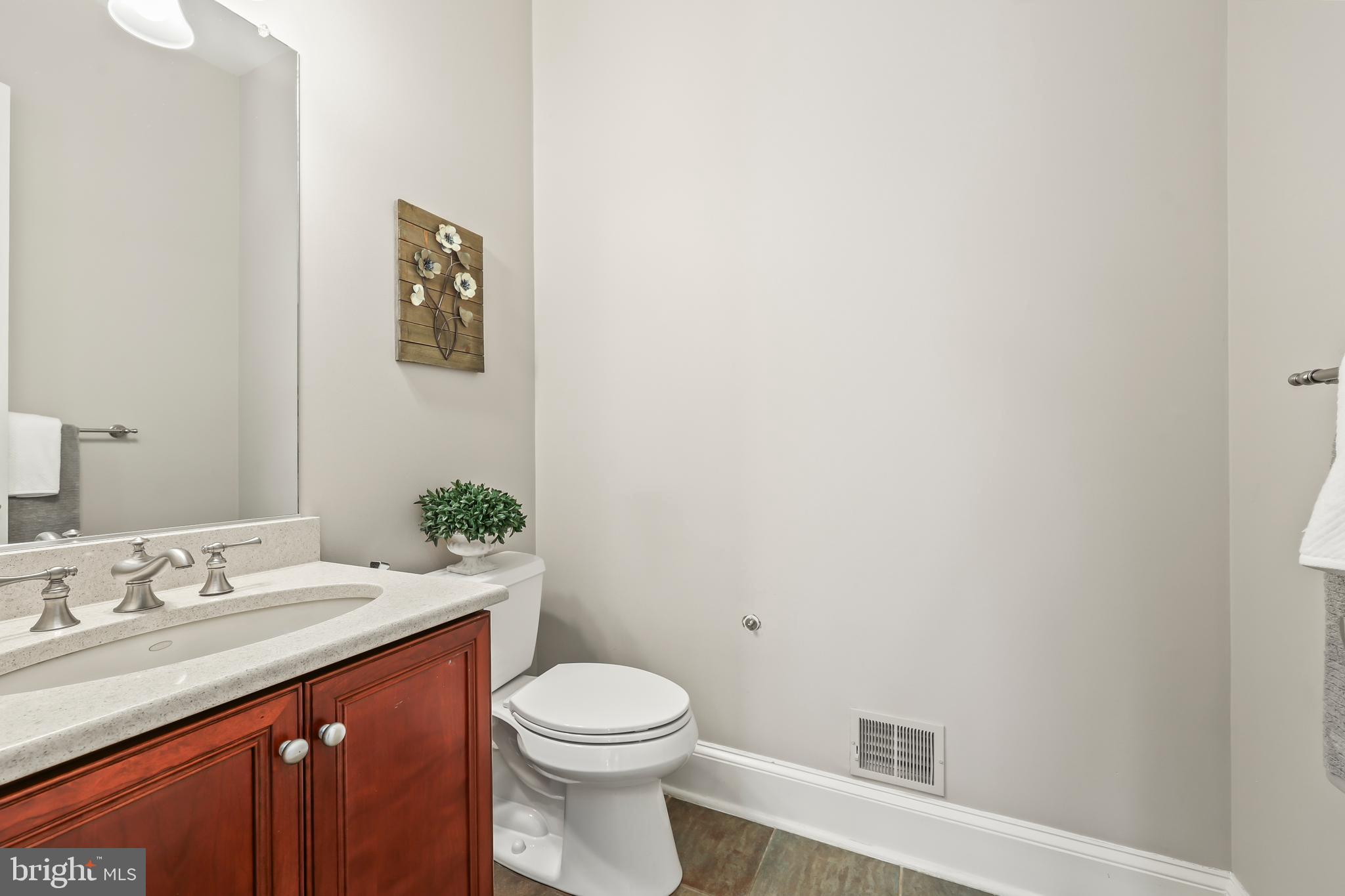 8340 Springhaven Garden Lane McLean, VA 22102 - Photo 22 of 76 a bathroom with a toilet a sink and mirror
