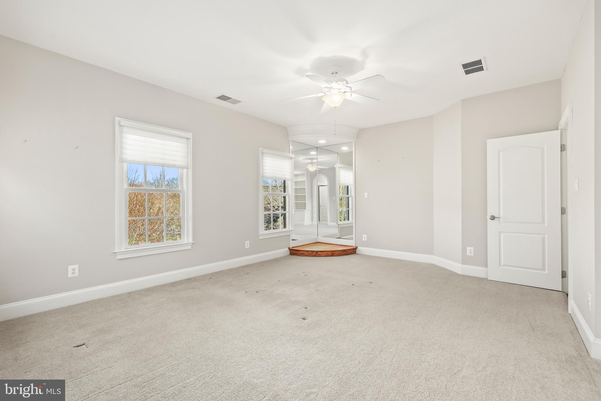 8340 Springhaven Garden Lane McLean, VA 22102 - Photo 44 of 76 an empty room with chandelier fan and windows
