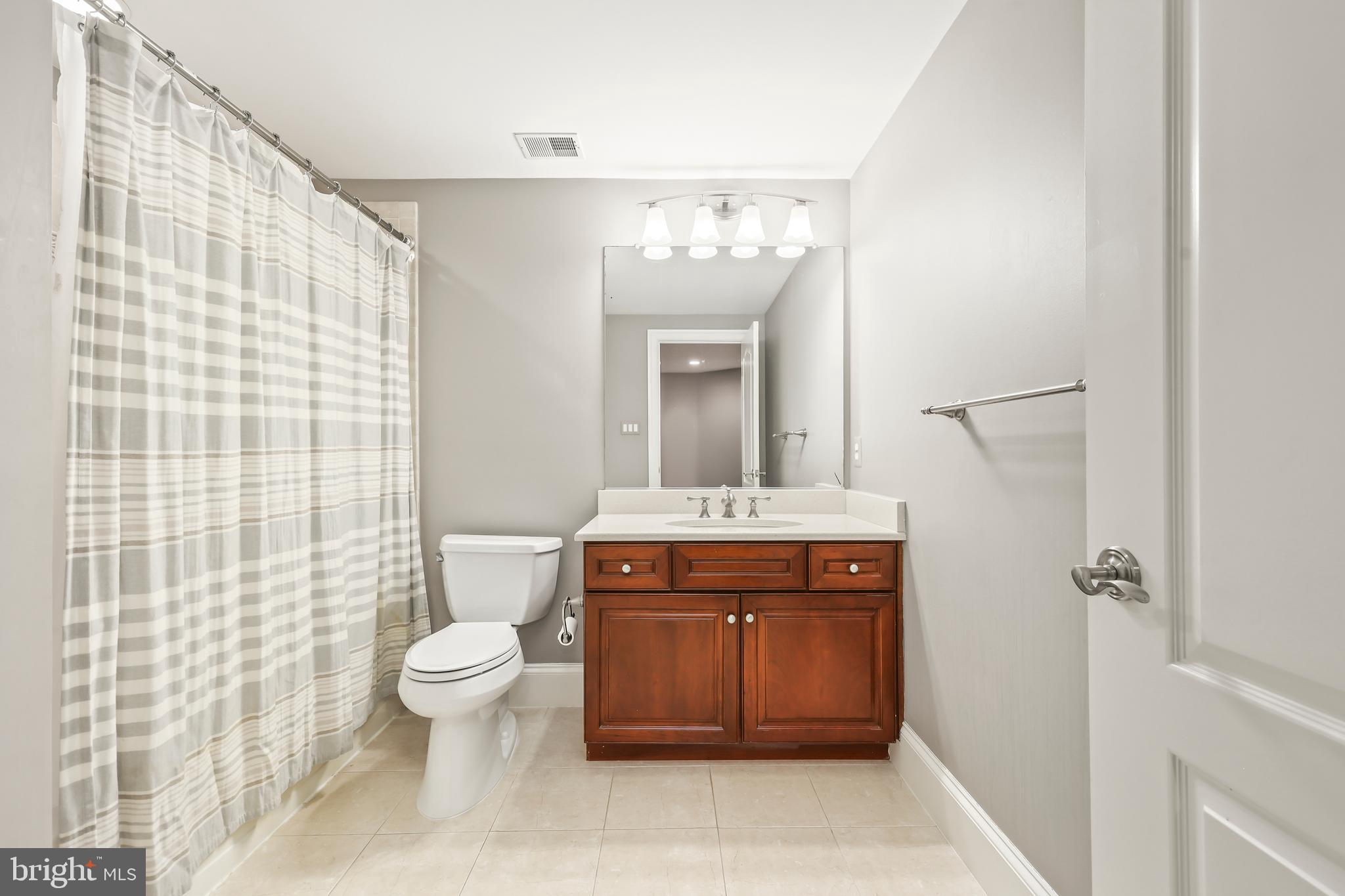 8340 Springhaven Garden Lane McLean, VA 22102 - Photo 51 of 76 a spacious bathroom with a granite countertop sink toilet and shower