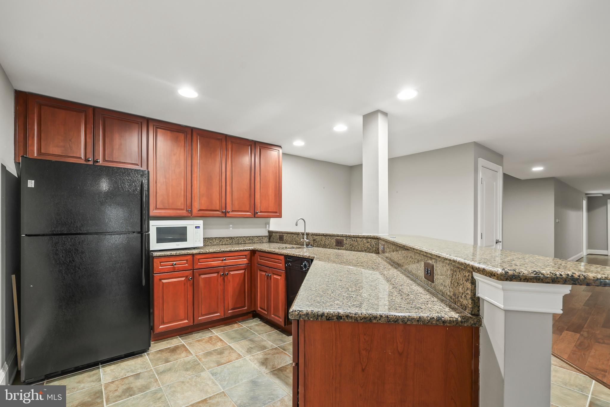 8340 Springhaven Garden Lane McLean, VA 22102 - Photo 54 of 76 a kitchen with a sink a refrigerator and cabinets