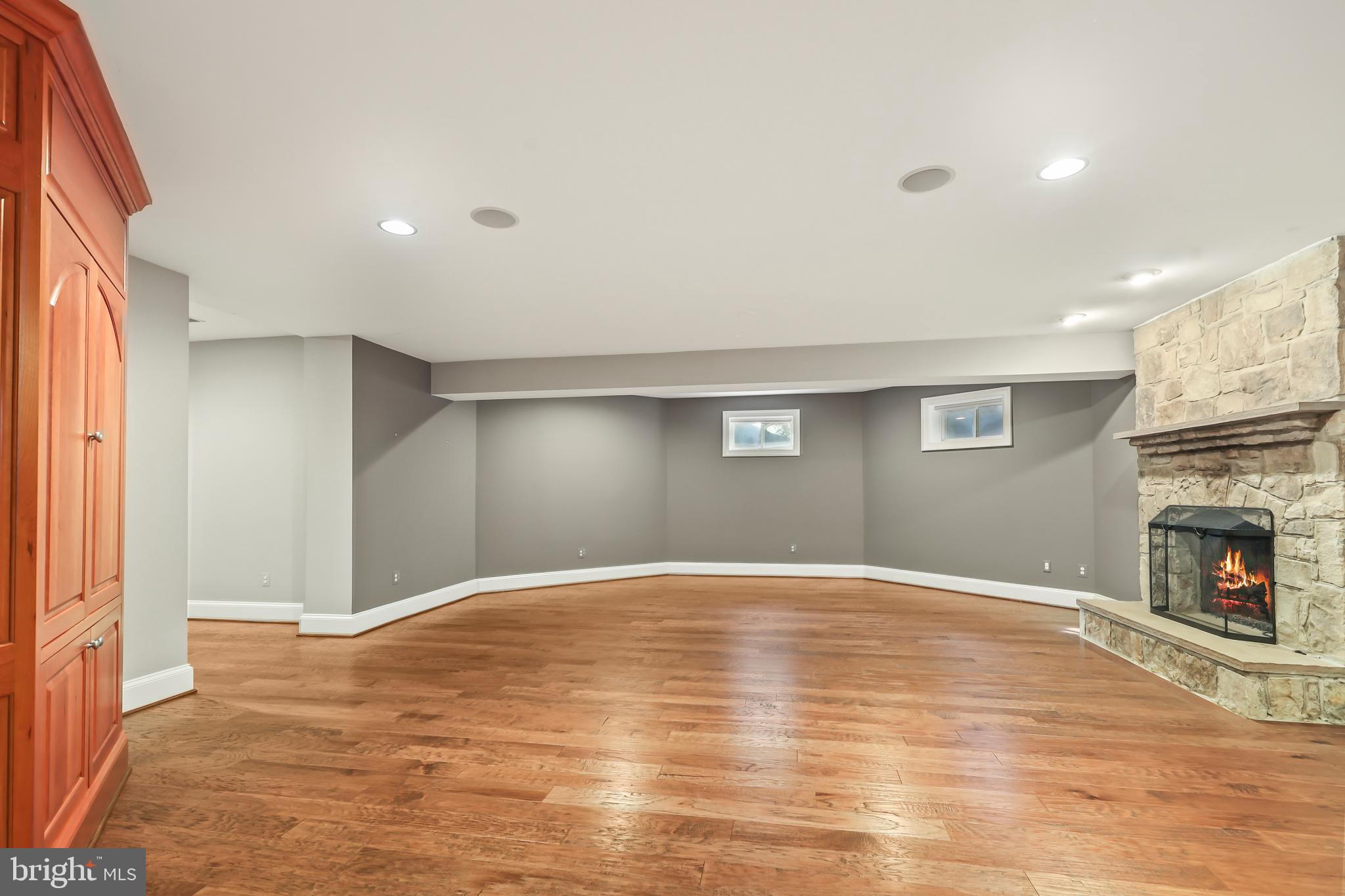 8340 Springhaven Garden Lane McLean, VA 22102 - Photo 56 of 76 a view of empty room with wooden floor and fireplace