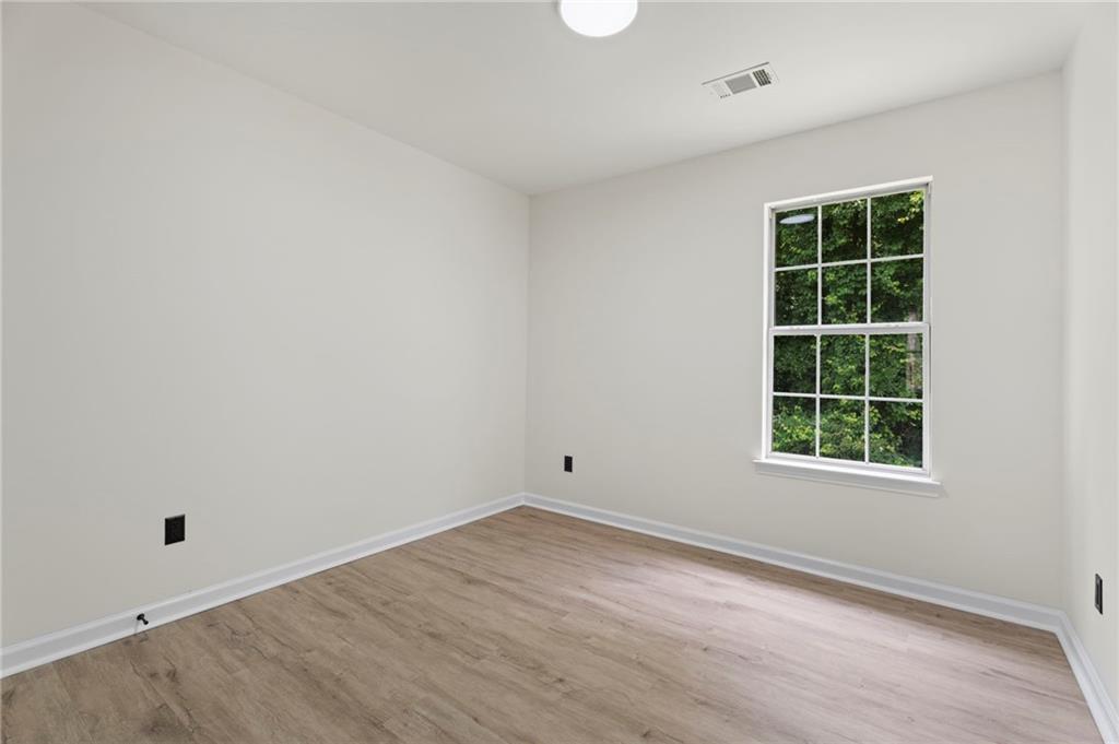 3602 Bristol Overlook Rex, GA 30273 - Photo 18 of 37 an empty room with wooden floor and windows