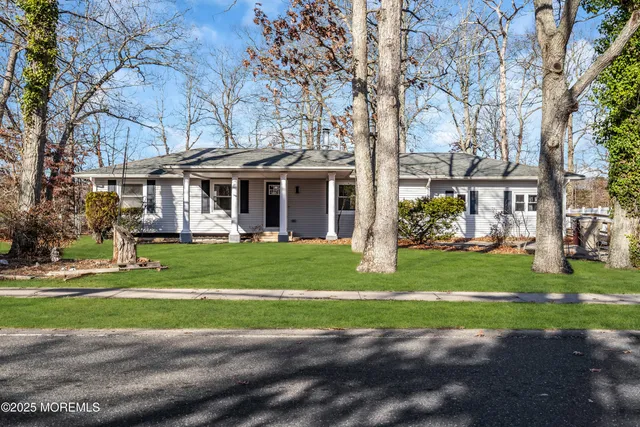 a front view of a house with a yard table and chairs