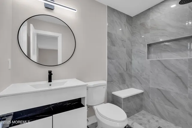 a bathroom with a toilet and a shower