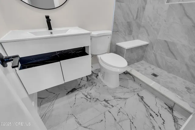 a bathroom with a sink a toilet and a mirror