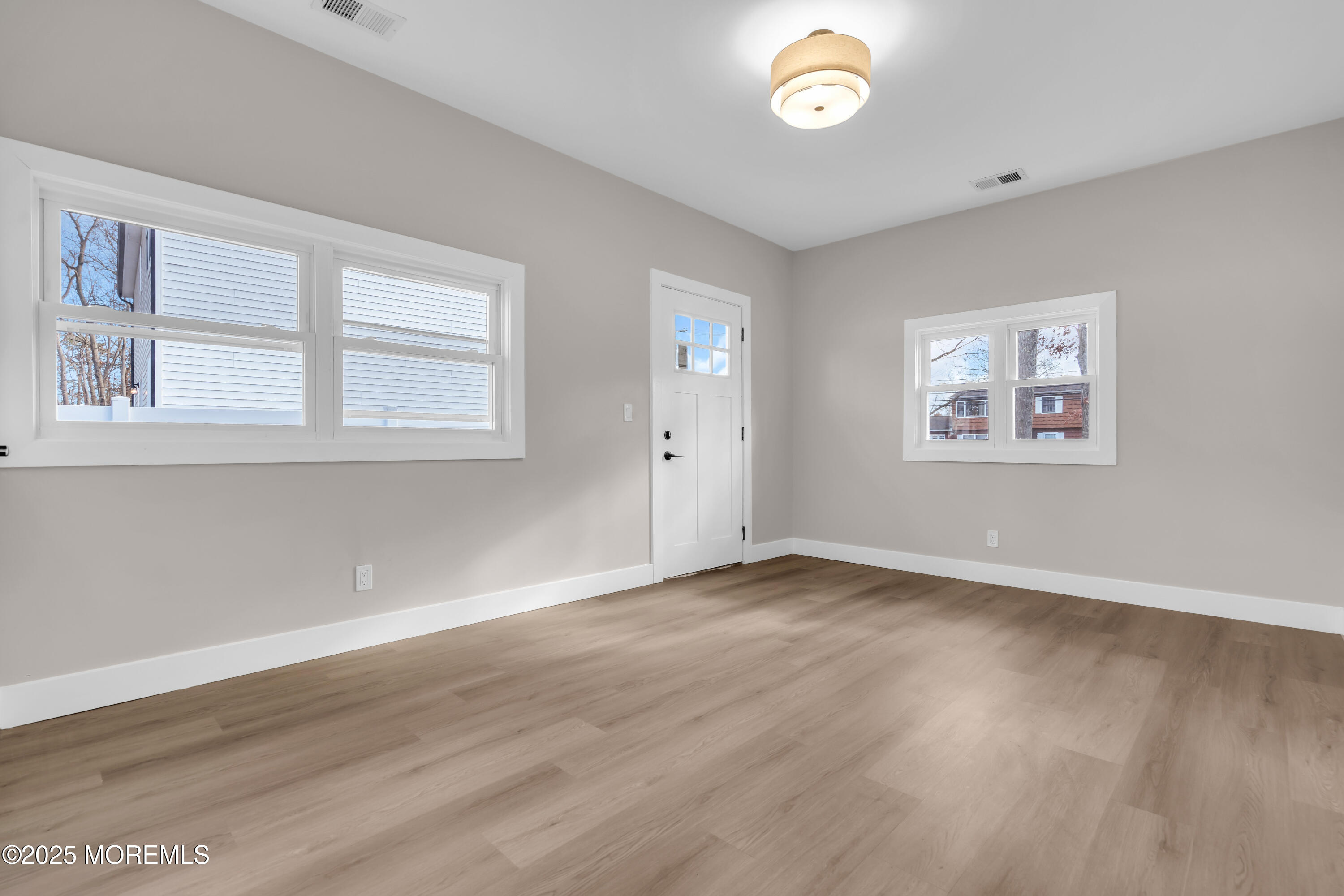 170 Station Road Bayville, NJ 08721 - Photo 27 of 36 a view of an empty room with a window and wooden floor