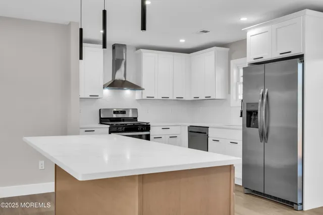a kitchen with stainless steel appliances a refrigerator and a stove