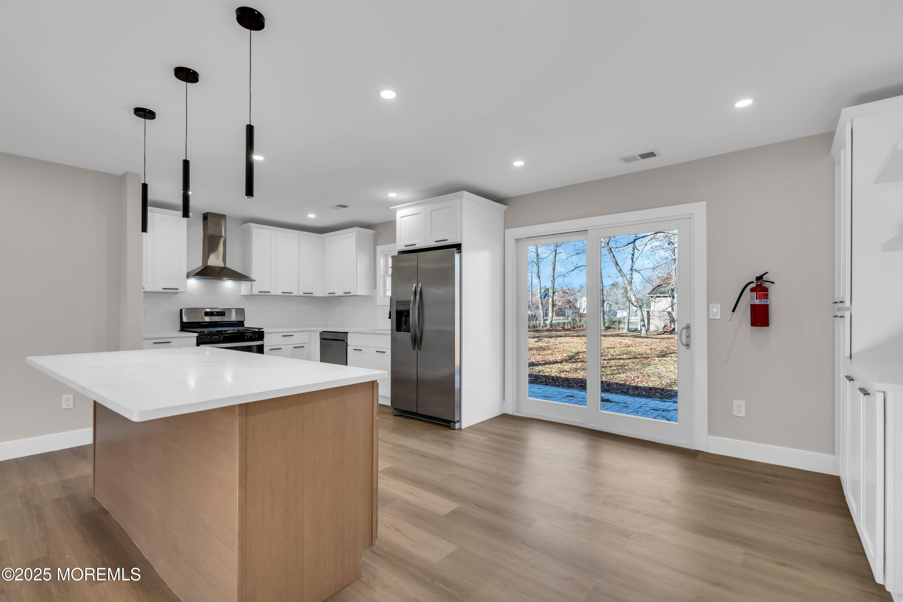 170 Station Road Bayville, NJ 08721 - Photo 4 of 36 a kitchen island with stainless steel appliances kitchen island wooden floor and window