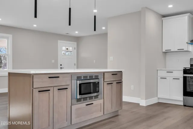 a kitchen with stainless steel appliances granite countertop a stove and a refrigerator