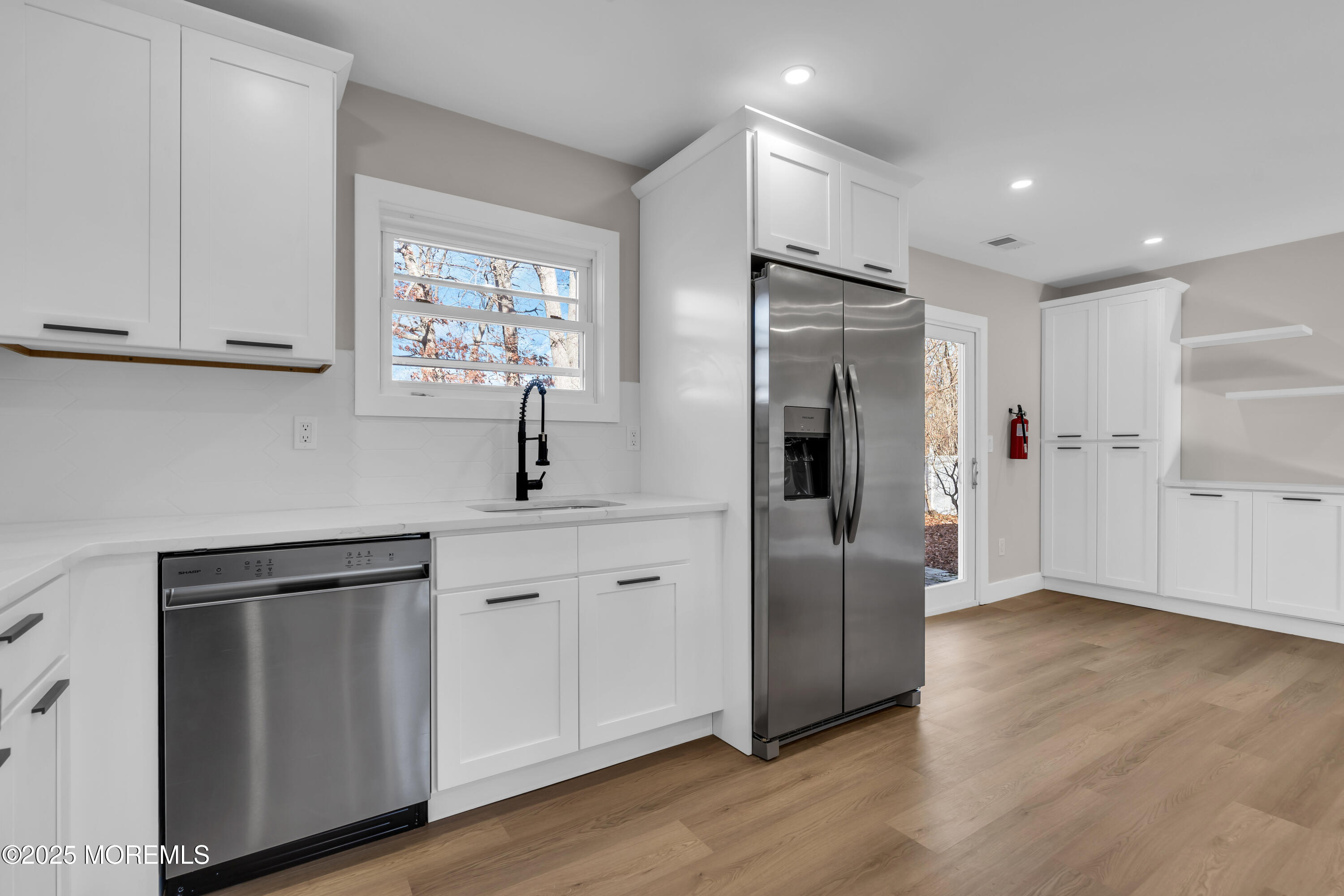 170 Station Road Bayville, NJ 08721 - Photo 8 of 36 a kitchen with stainless steel appliances a refrigerator sink and cabinets