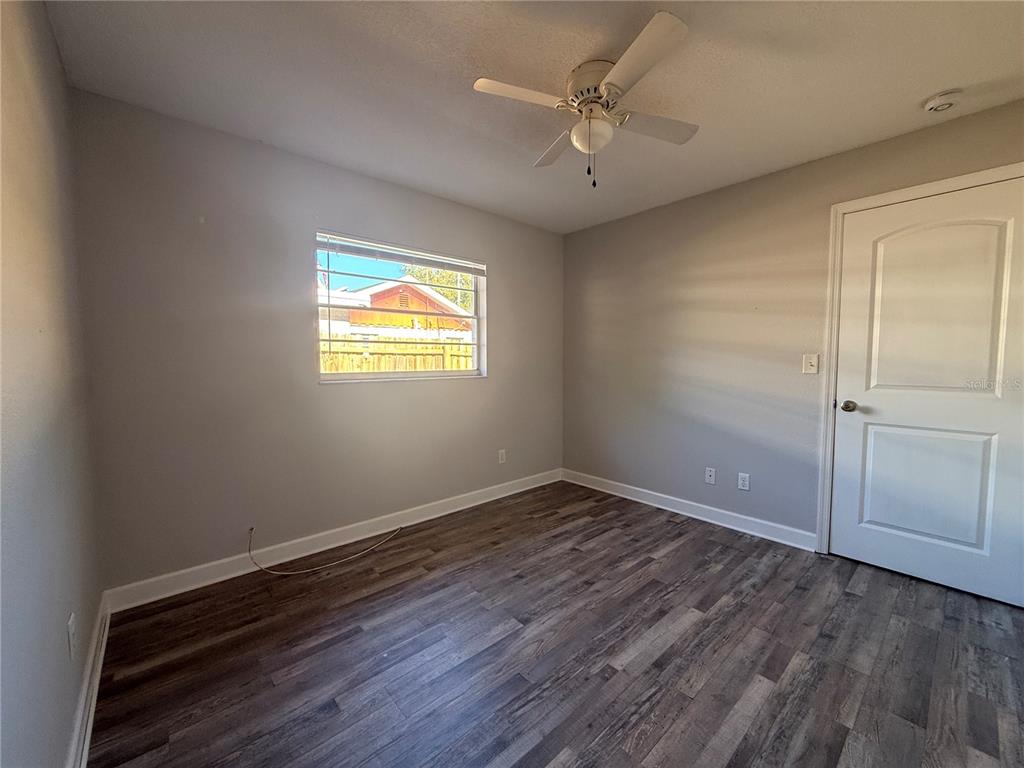 5839 12th Street Zephyrhills, FL 33542 - Photo 11 of 20 wooden floor in an empty room with a window