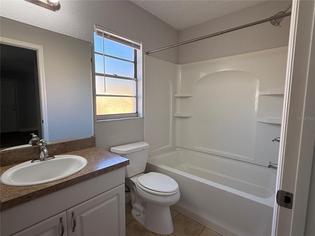 5839 12th Street Zephyrhills, FL 33542 - Photo 15 of 20 a bathroom with a sink toilet and shower