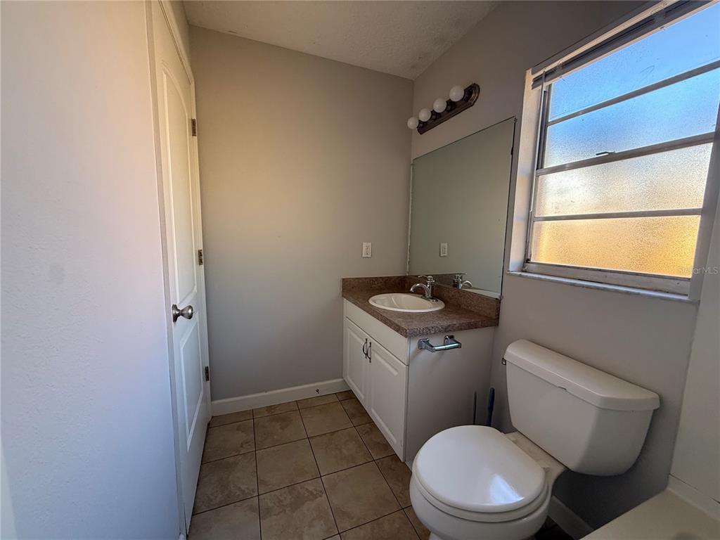 5839 12th Street Zephyrhills, FL 33542 - Photo 16 of 20 a white toilet sitting next to a bathroom sink
