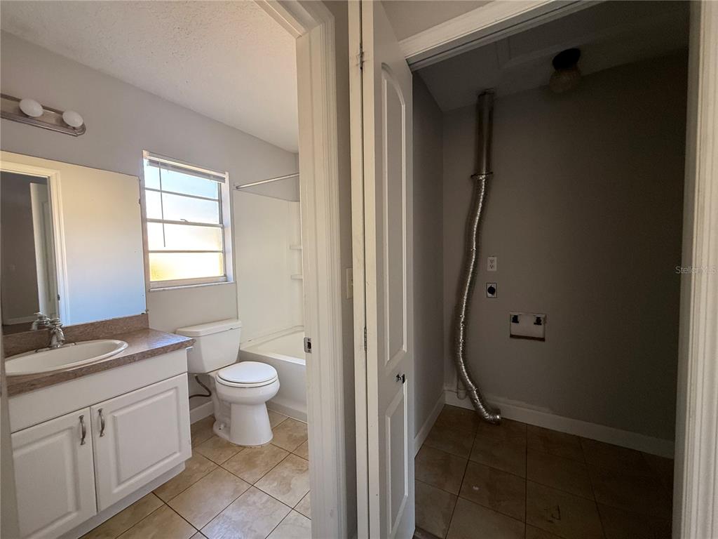 5839 12th Street Zephyrhills, FL 33542 - Photo 17 of 20 a bathroom with a granite countertop sink toilet and shower