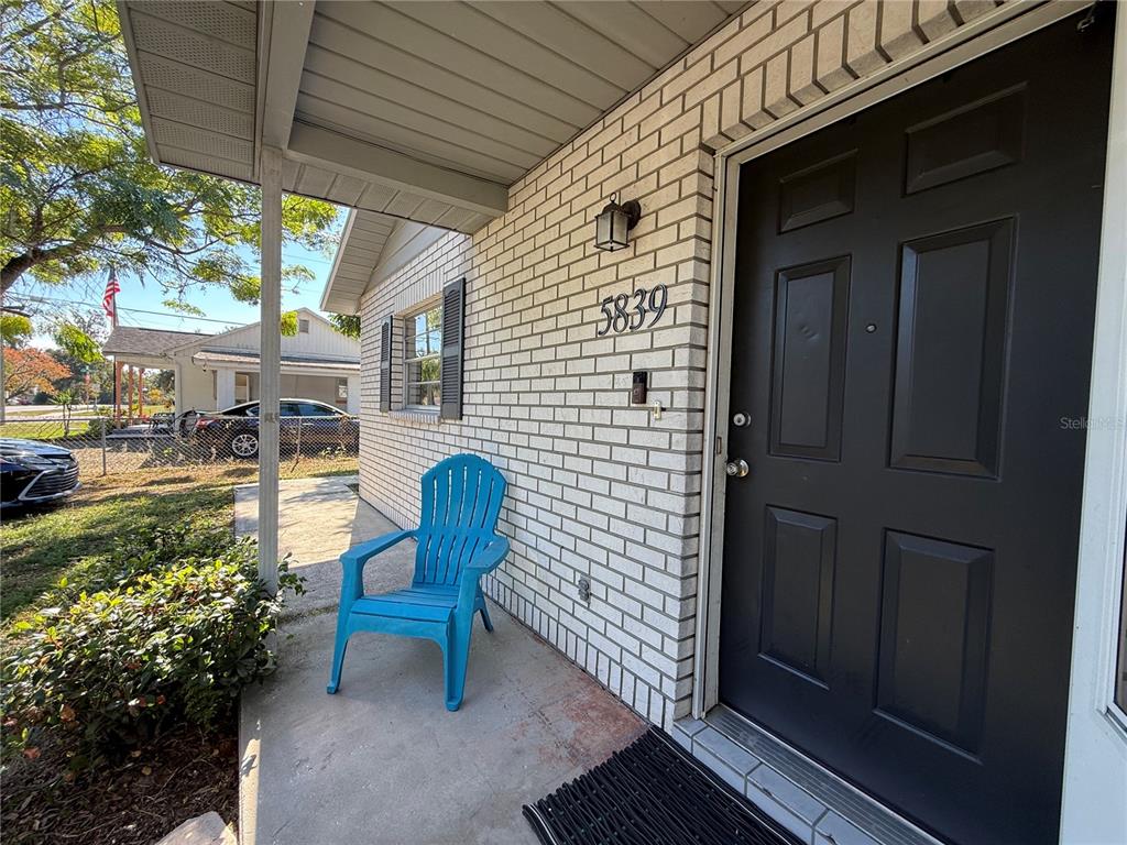 5839 12th Street Zephyrhills, FL 33542 - Photo 3 of 20 a view of a chair and table in the balcony