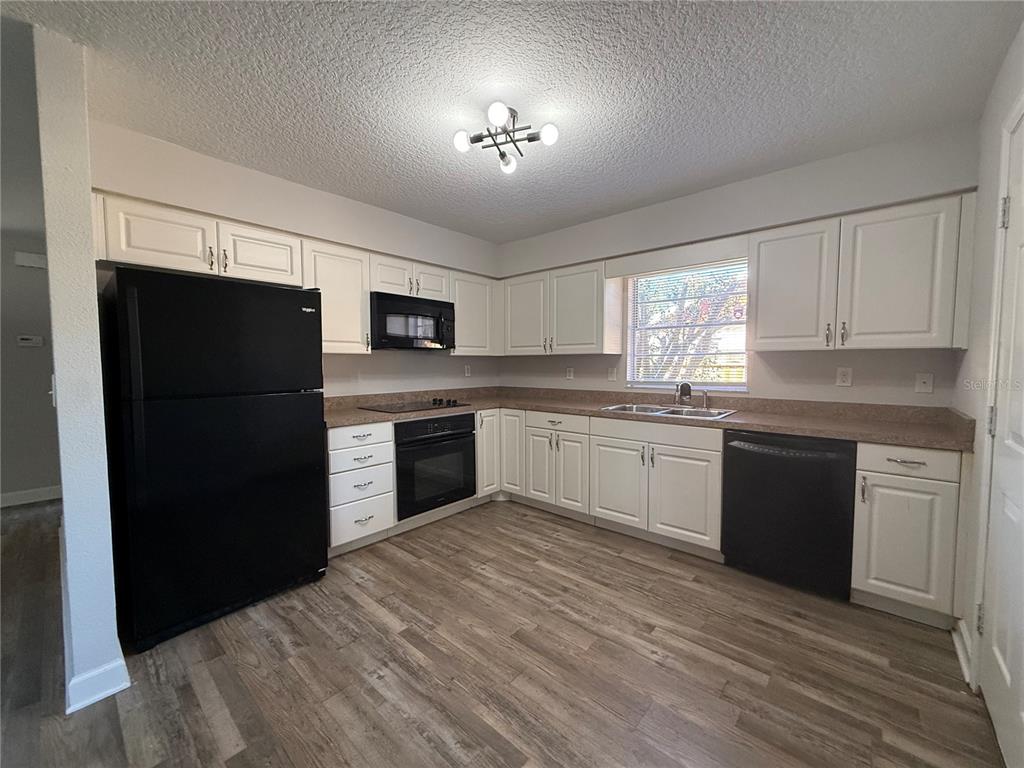 5839 12th Street Zephyrhills, FL 33542 - Photo 4 of 20 a kitchen with a refrigerator stove and microwave