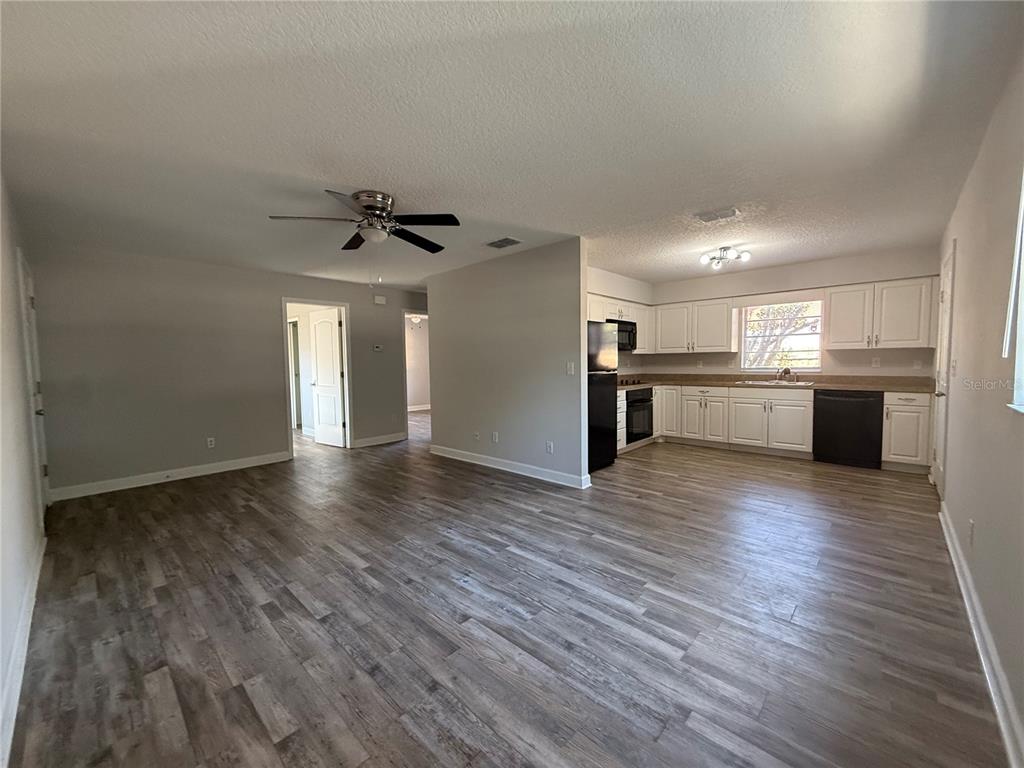 5839 12th Street Zephyrhills, FL 33542 - Photo 6 of 20 a view of kitchen with cabinets and wooden floor