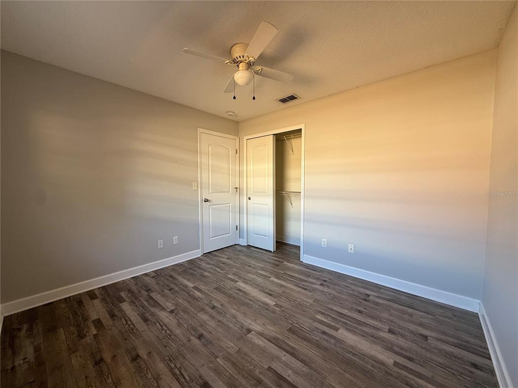 5839 12th Street Zephyrhills, FL 33542 - Photo 10 of 20 a view of an empty room with wooden floor