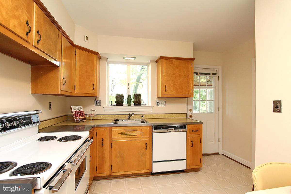 10109 Portland Place Silver Spring, MD 20901 - Photo 12 of 26 a kitchen with a stove a sink and a microwave