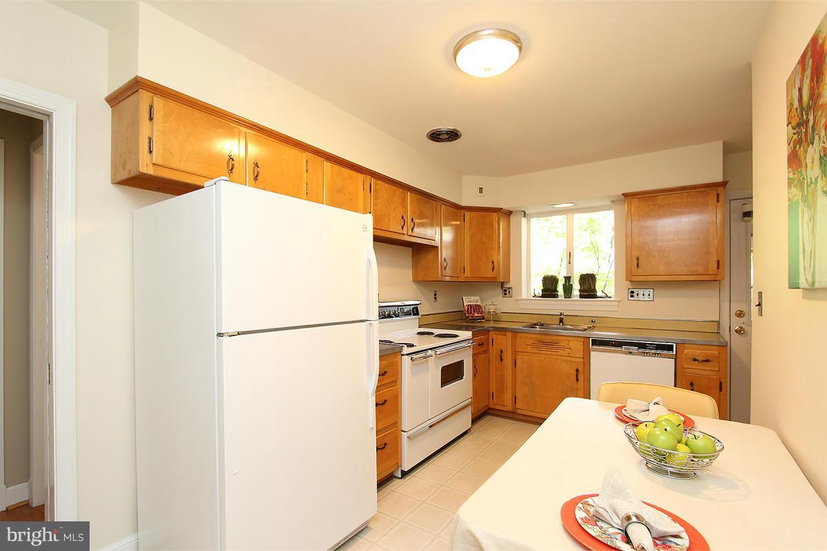 10109 Portland Place Silver Spring, MD 20901 - Photo 13 of 26 a kitchen with a sink a stove and refrigerator