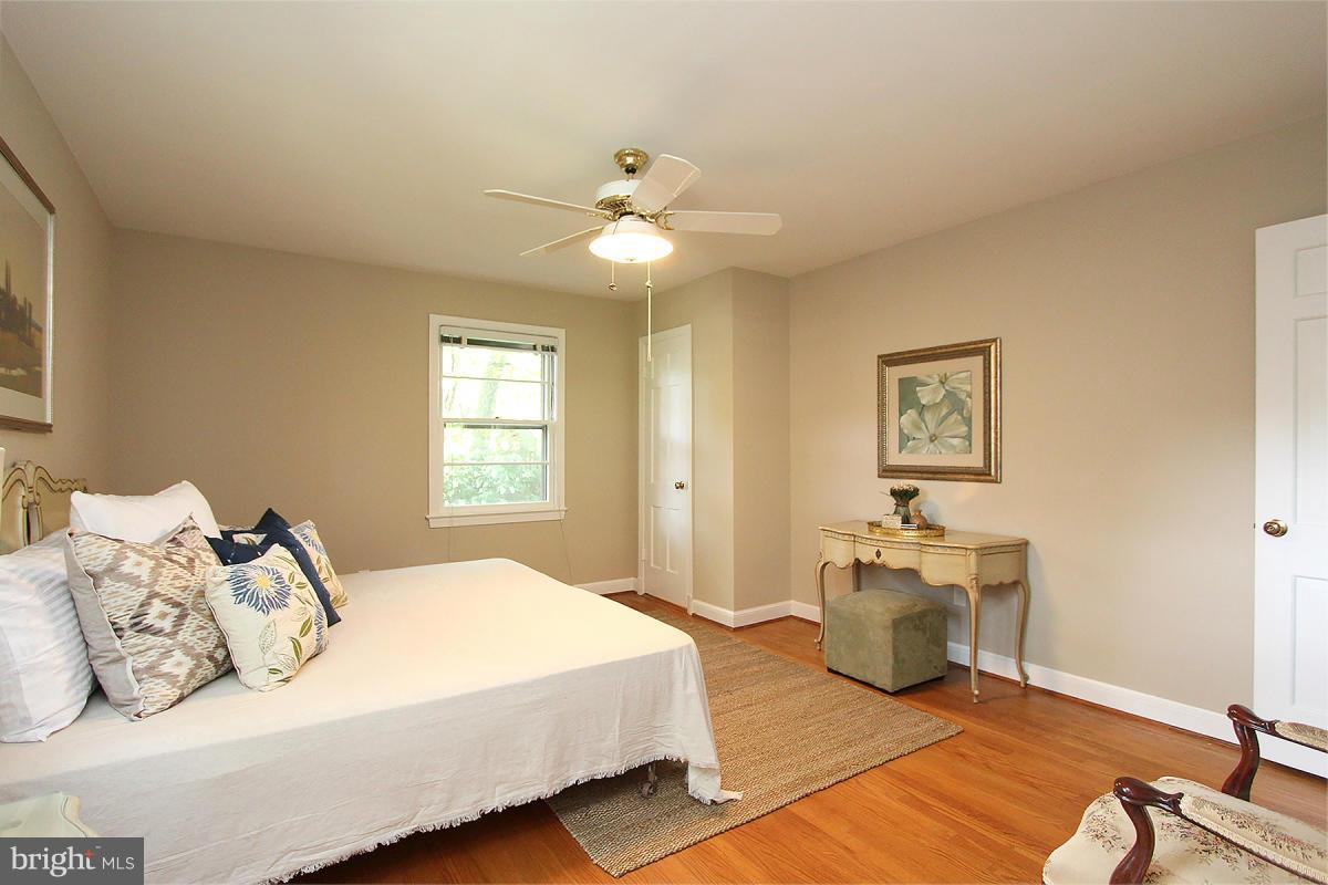 10109 Portland Place Silver Spring, MD 20901 - Photo 15 of 26 a bedroom with a bed and ceiling fan
