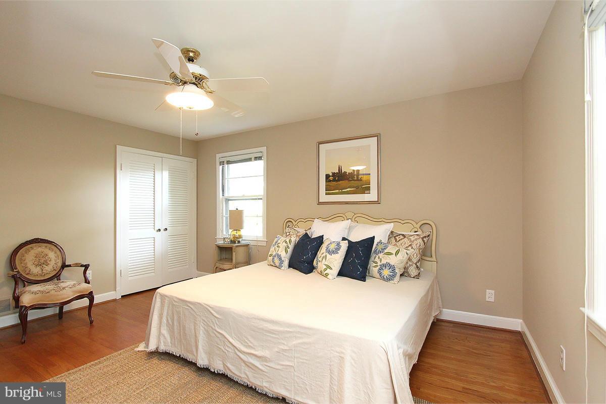 10109 Portland Place Silver Spring, MD 20901 - Photo 17 of 26 a bedroom with a bed and a chandelier