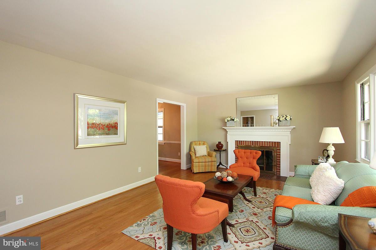 10109 Portland Place Silver Spring, MD 20901 - Photo 3 of 26 a living room with furniture a fireplace and a table