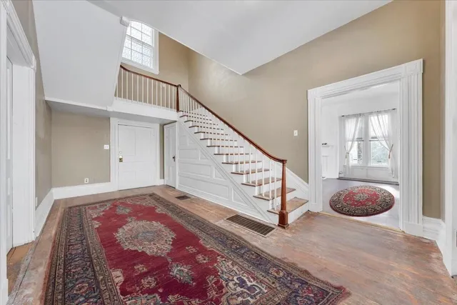 a living room with furniture a chandelier and a fireplace