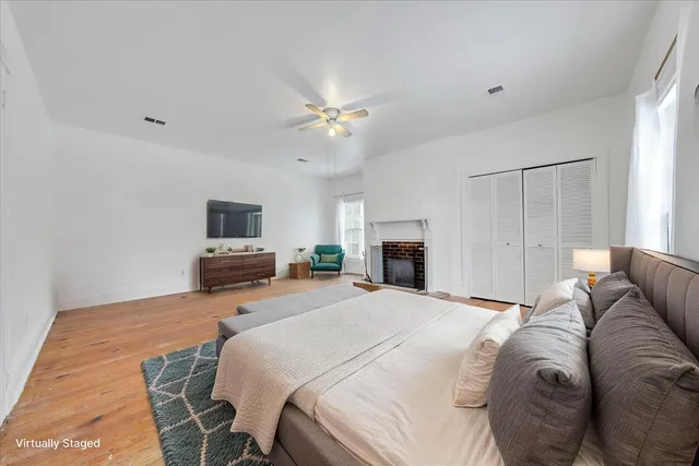 a bedroom with a bed flat screen tv and a couch