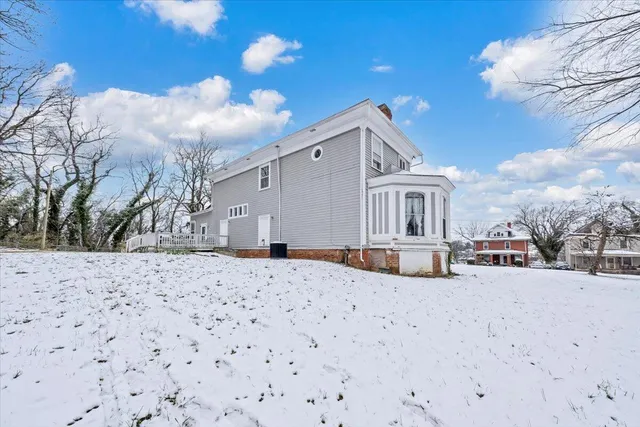 a house that has a tree in front of it