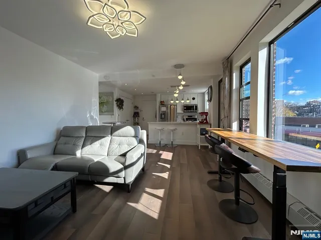 a living room with furniture and a floor to ceiling window
