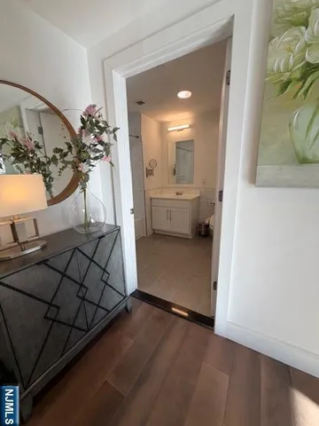 a bathroom with a bathtub toilet sink and mirror