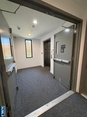 a view of a hallway to rooms