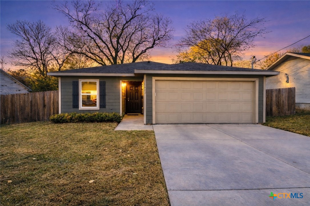 1411 North 10th Street Killeen, TX 76541 - Photo 1 of 21 a front view of a house with a yard and garage