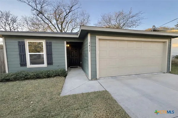 a front view of a house with garage