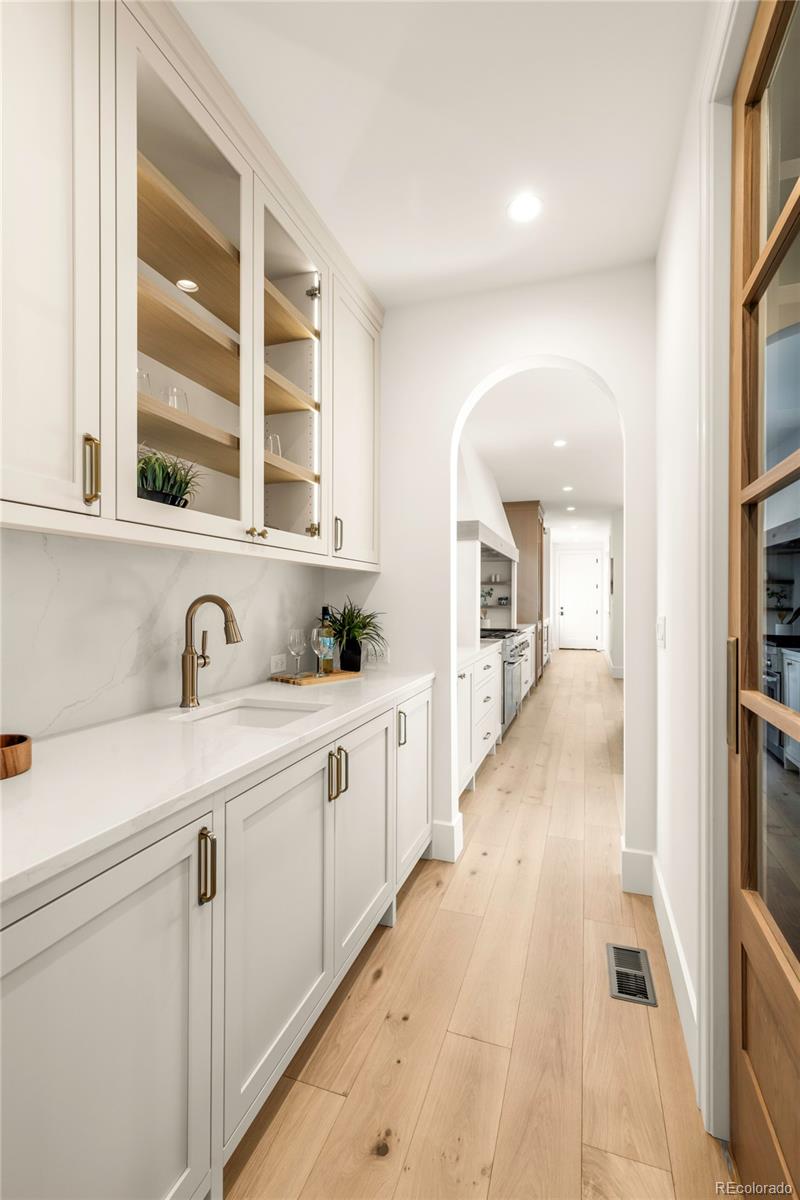 2658 South Adams Street Denver, CO 80210 - Photo 13 of 34 a large white kitchen with sink and windows