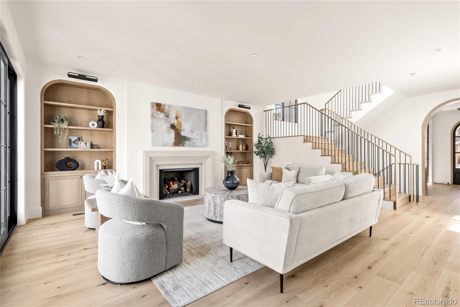 2658 South Adams Street Denver, CO 80210 - Photo 16 of 34 a living room with furniture a fireplace and a flat screen tv
