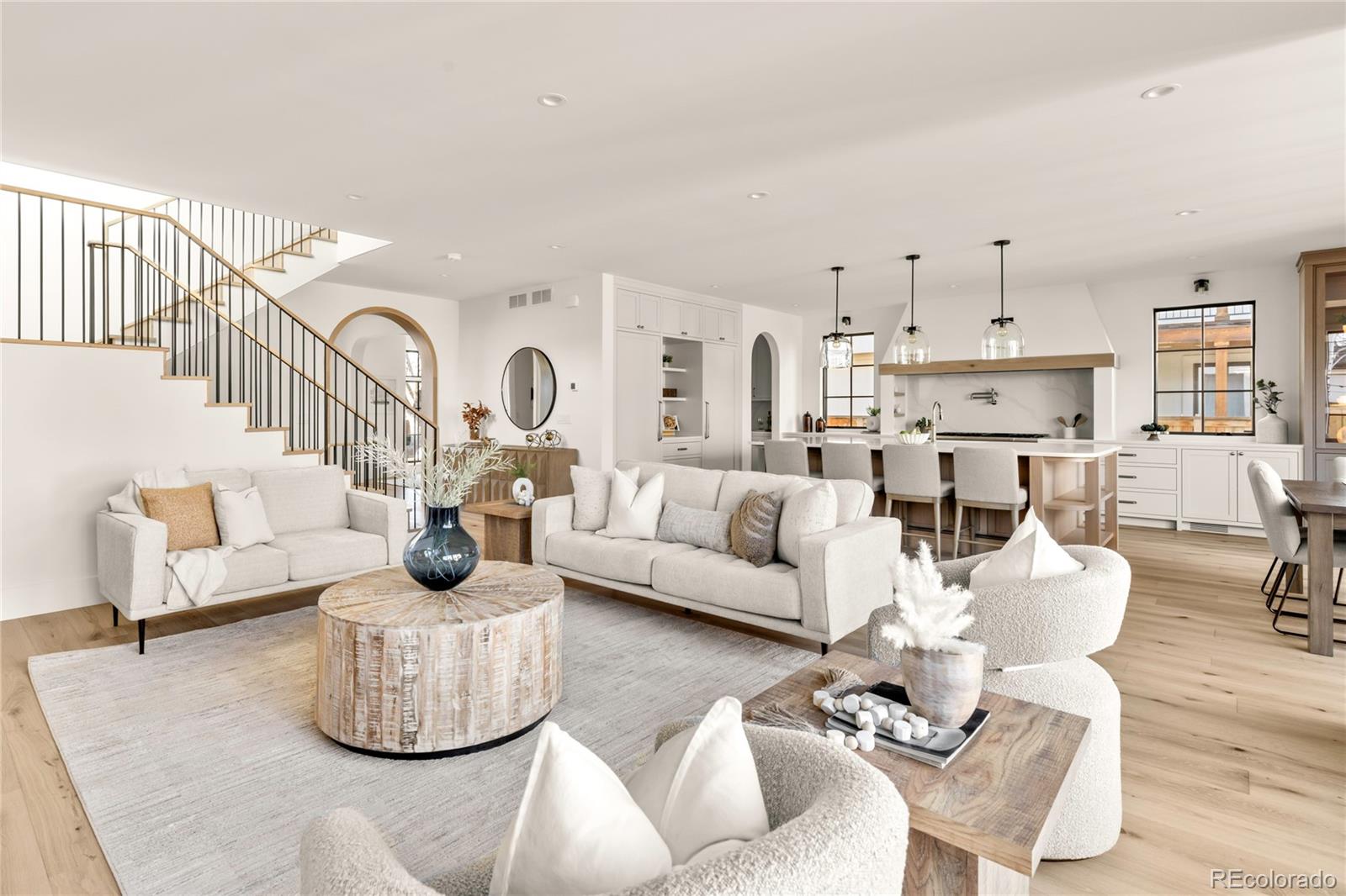 2658 South Adams Street Denver, CO 80210 - Photo 17 of 34 a living room with furniture and a dining table with kitchen view