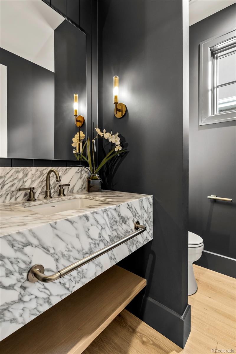 2658 South Adams Street Denver, CO 80210 - Photo 18 of 34 a bathroom with a sink and a mirror