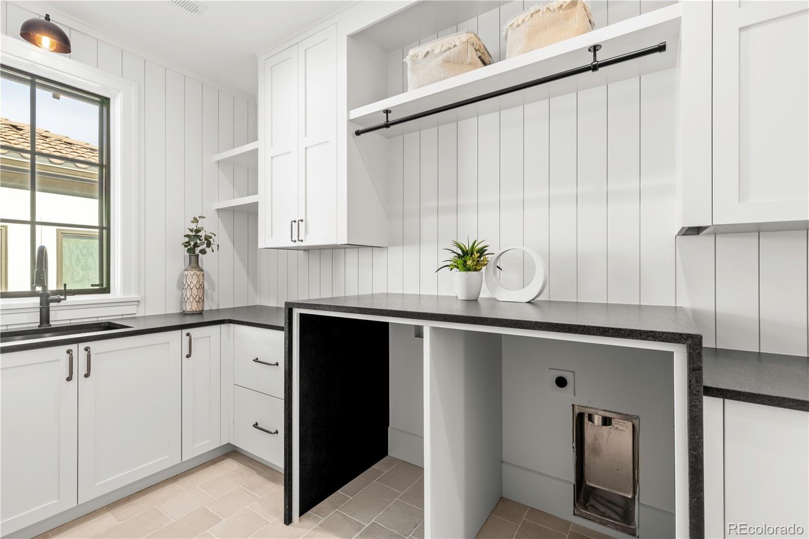 2658 South Adams Street Denver, CO 80210 - Photo 26 of 34 a kitchen with stainless steel appliances granite countertop a sink window and cabinets