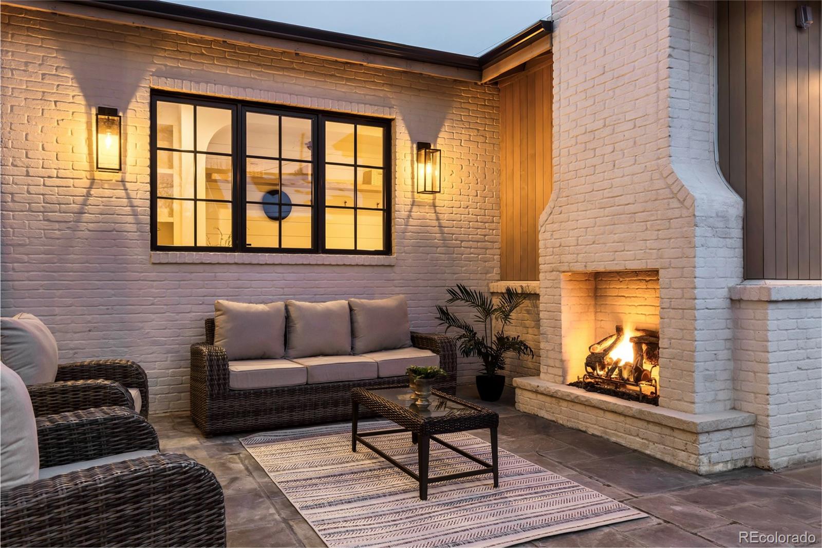 2658 South Adams Street Denver, CO 80210 - Photo 34 of 34 a living room with furniture a fireplace and a flat screen tv