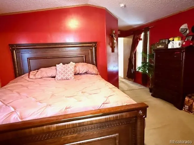 a bed sitting in a bedroom next to a yard