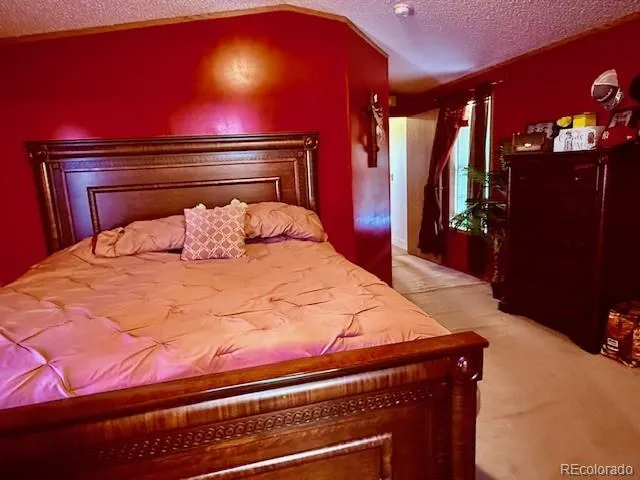 a bedroom with a bed and a closet with mirror