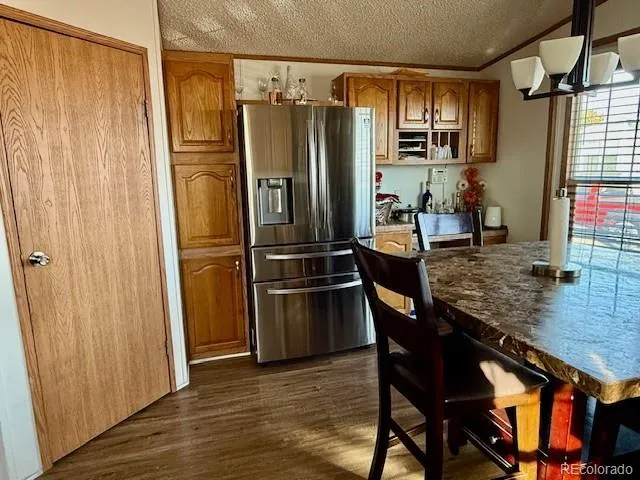a kitchen with stainless steel appliances granite countertop a refrigerator and a stove top oven