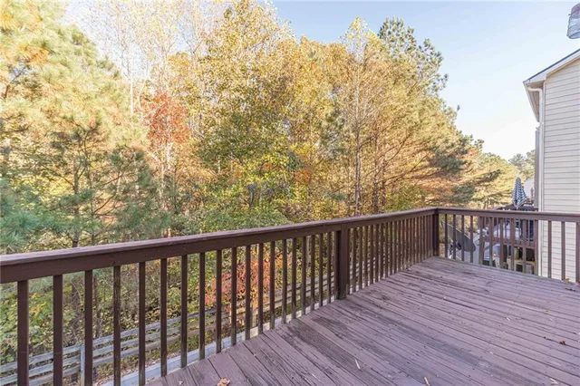 a balcony with wooden floor and fence