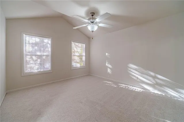 a view of a livingroom with a ceiling fan and window