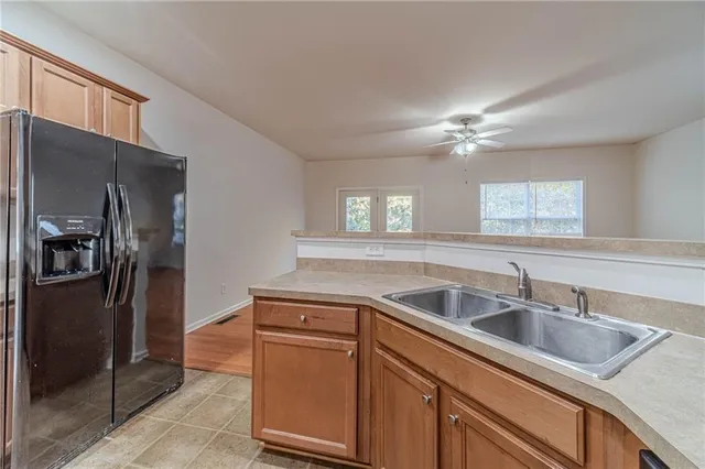a kitchen that has a sink cabinets counter space and stainless steel appliances